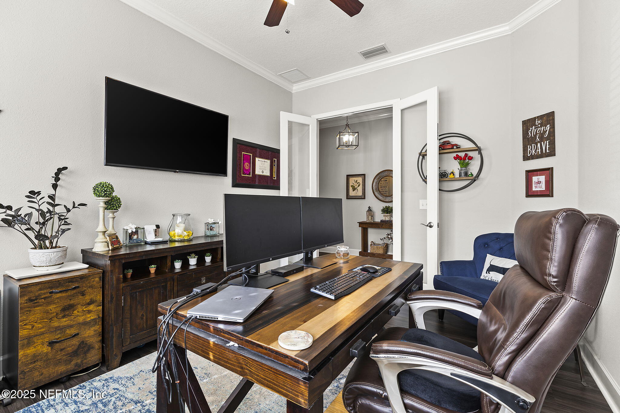 45 Manor Lane St. Johns, FL 32259 - Photo 12 of 47 a work room with furniture and a flat screen tv