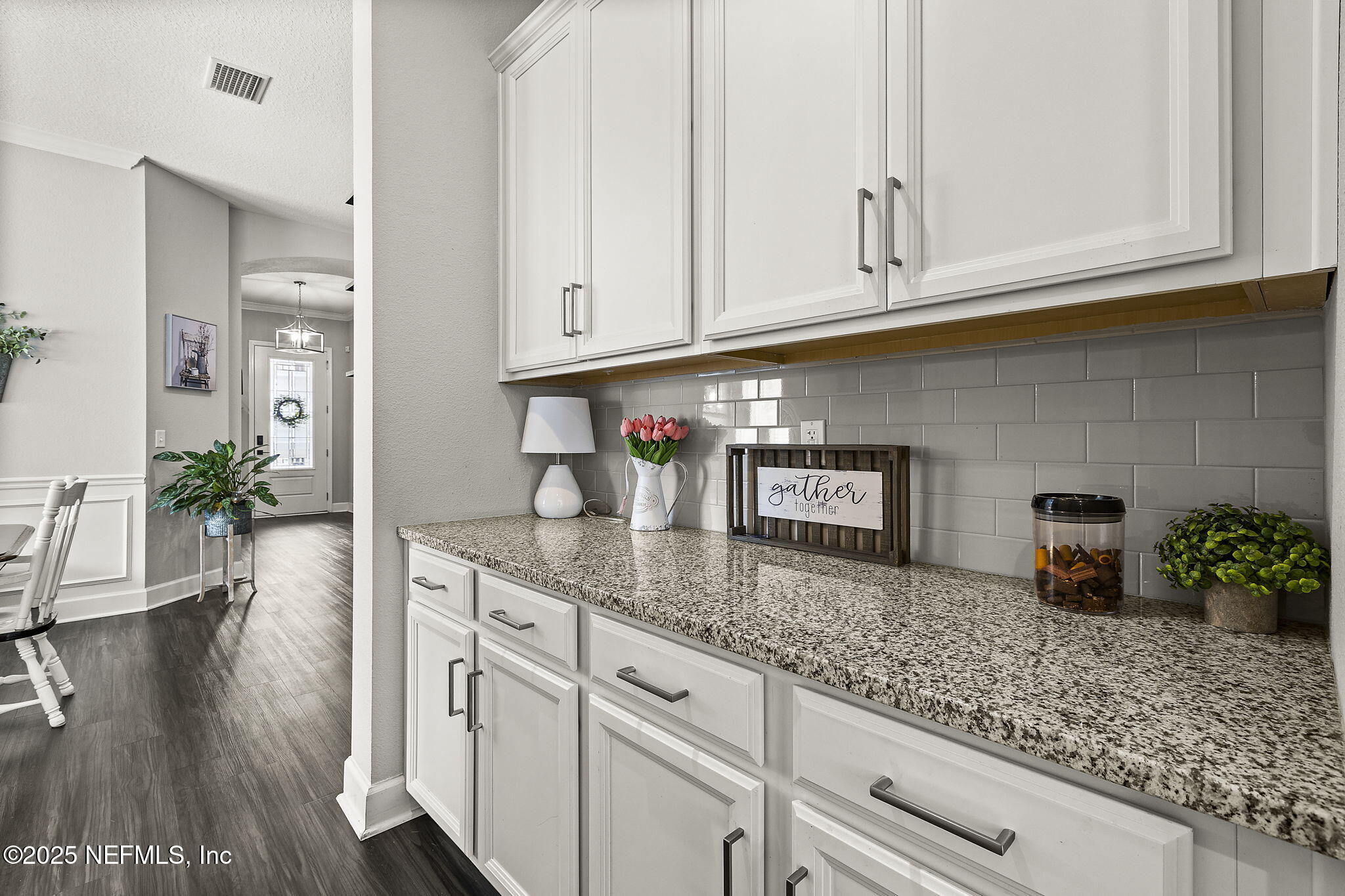 45 Manor Lane St. Johns, FL 32259 - Photo 13 of 47 a kitchen with stainless steel appliances granite countertop a sink a window and white cabinets