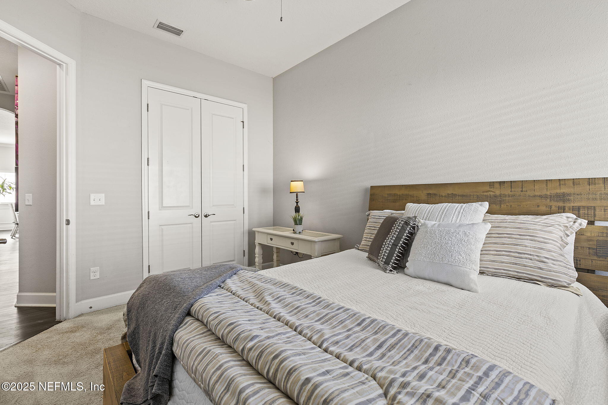 45 Manor Lane St. Johns, FL 32259 - Photo 35 of 47 a bedroom with a bed and a night stand