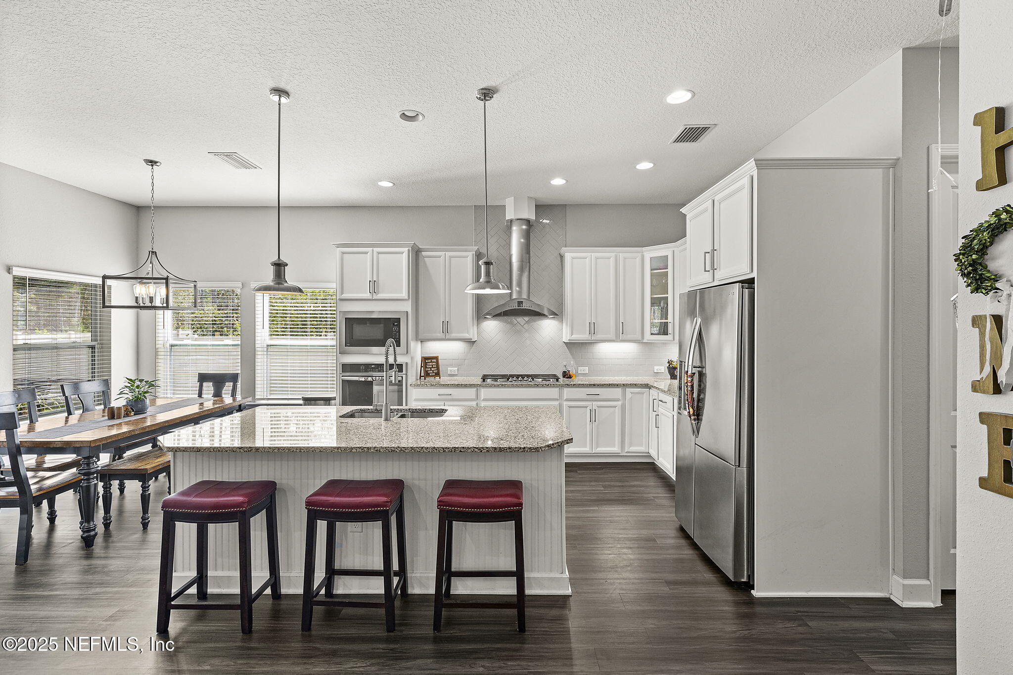45 Manor Lane St. Johns, FL 32259 - Photo 7 of 47 a large kitchen with kitchen island a dining table and chairs