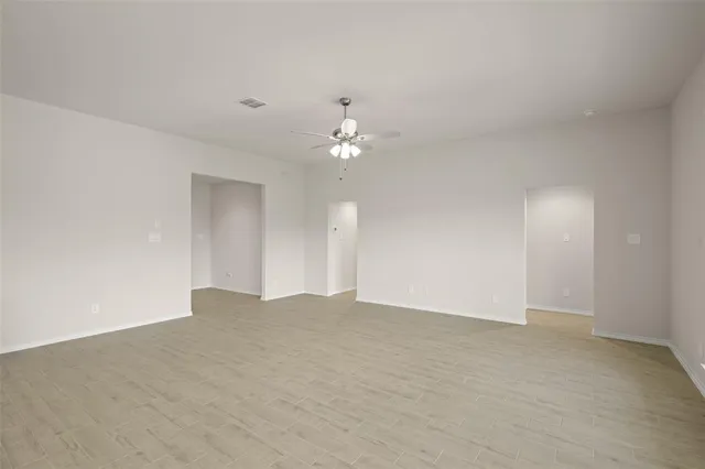 a view of an empty room with a ceiling fan