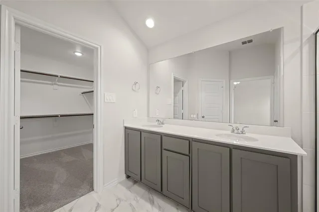 a bathroom with a double vanity sink and mirror