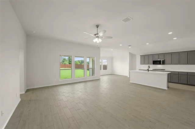 a view of a kitchen with a sink and a window