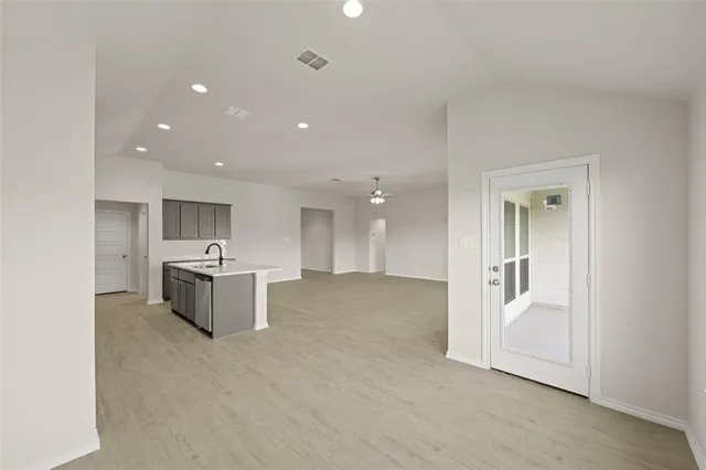 a view of a room with kitchen refrigerator and a sink