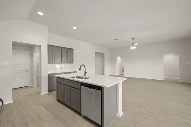 a kitchen with a sink a counter space and appliances