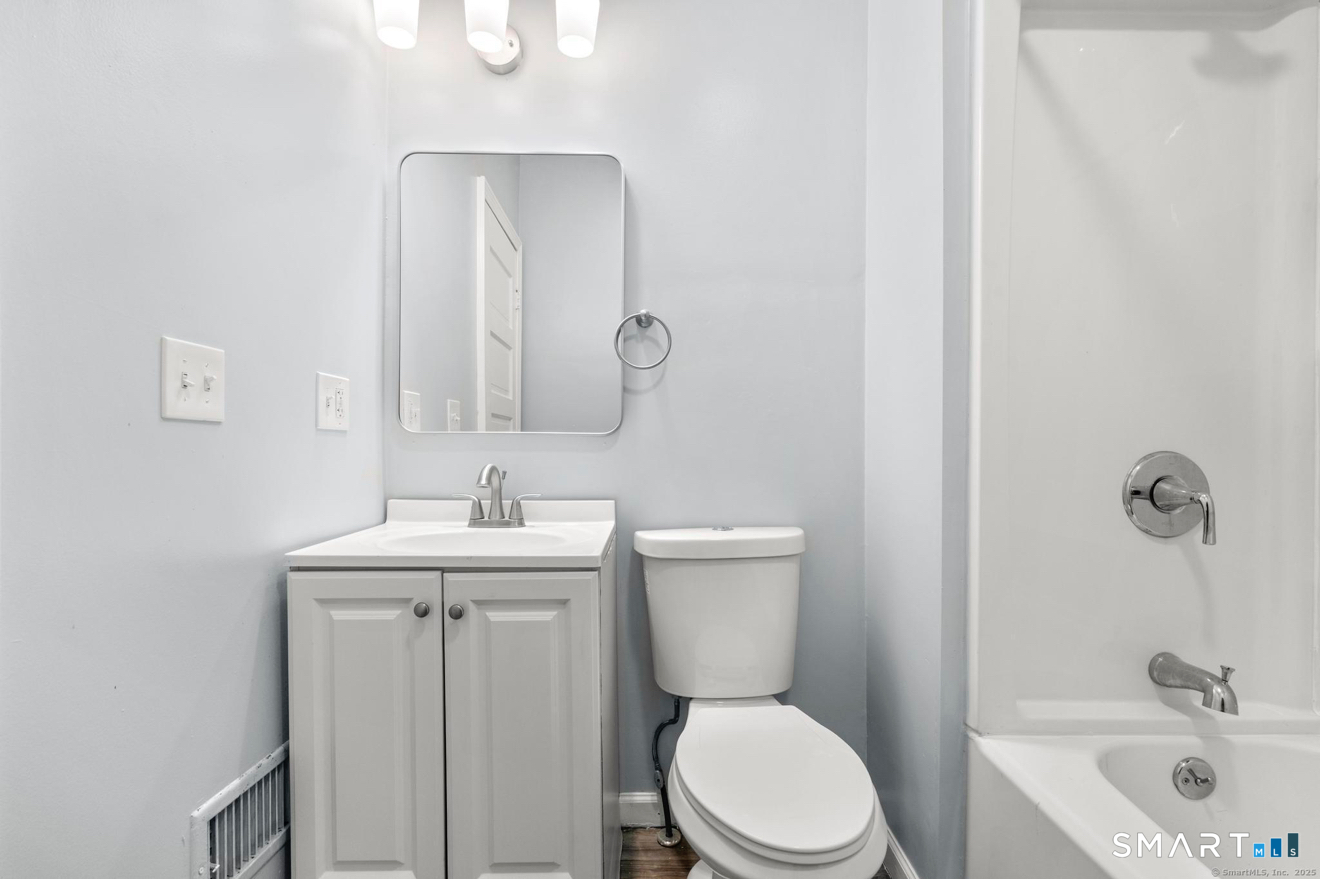 292 West Ivy Street New Haven, CT 06511 - Photo 13 of 16 a bathroom with a toilet a sink and mirror