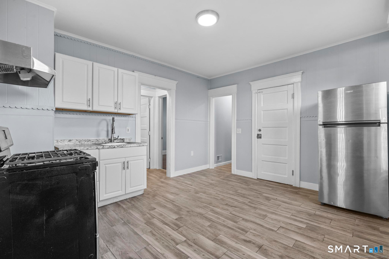 292 West Ivy Street New Haven, CT 06511 - Photo 8 of 16 a kitchen with granite countertop a refrigerator stove top oven and sink