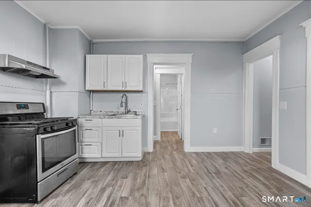 a kitchen with stainless steel appliances granite countertop a stove and a sink