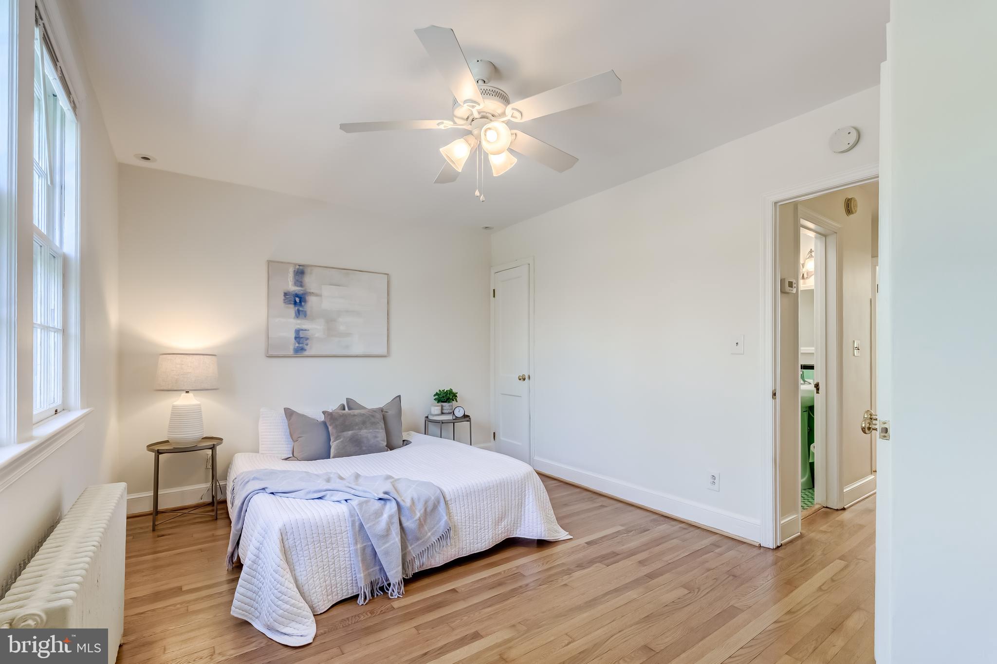 2217 39th Place Northwest Washington, DC 20007 - Photo 10 of 28 a bedroom with a bed and a chandelier