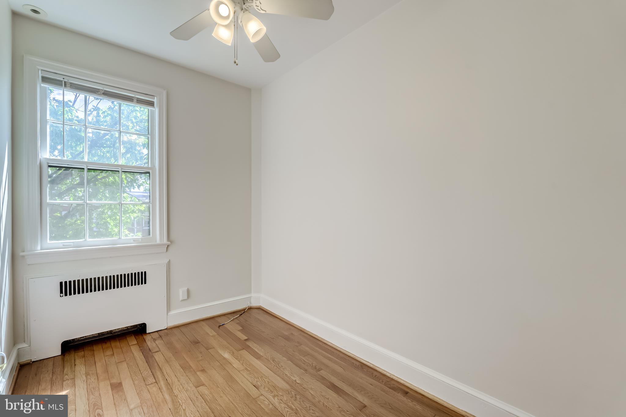 2217 39th Place Northwest Washington, DC 20007 - Photo 14 of 28 an empty room with wooden floor and windows