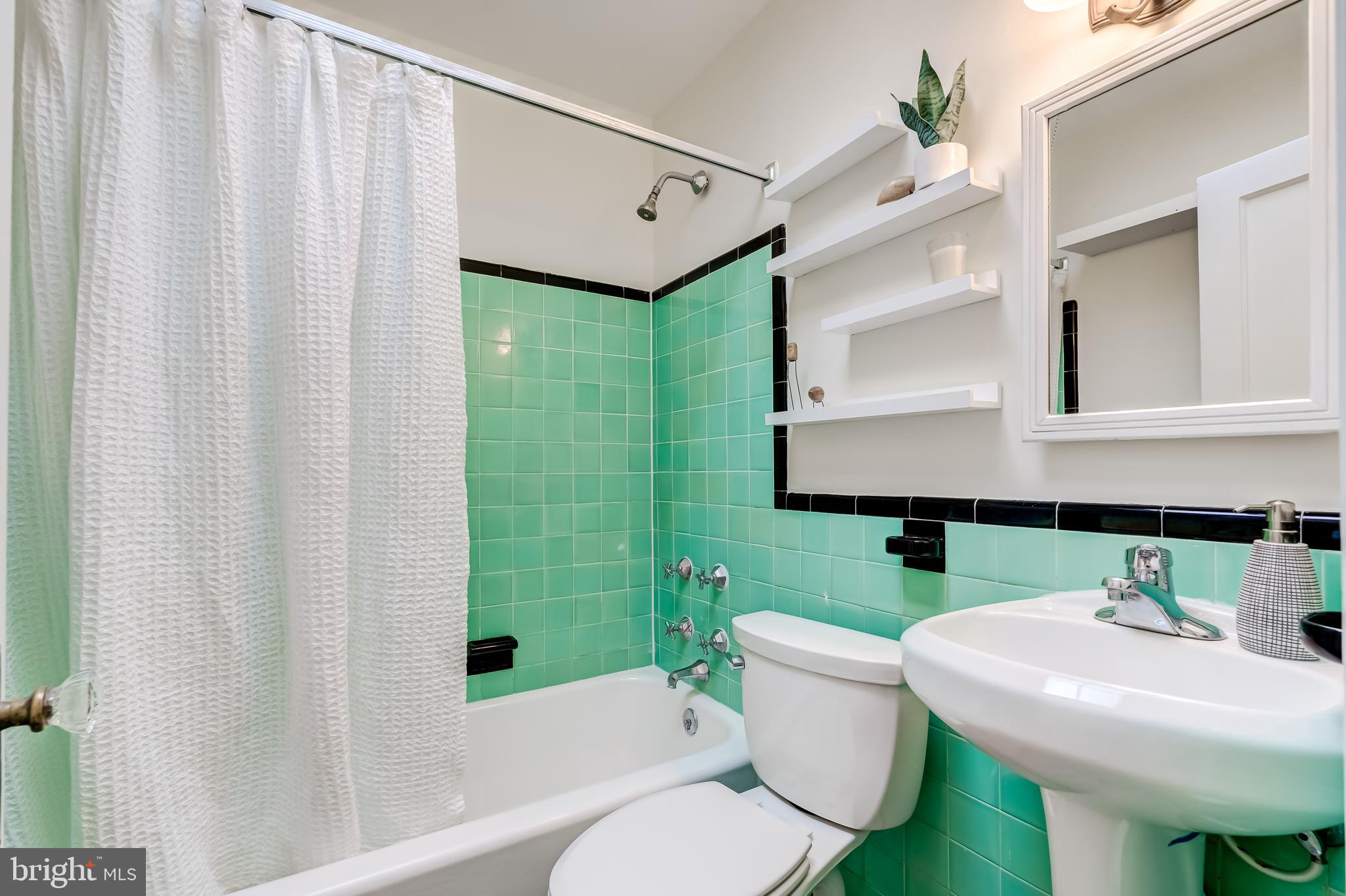 2217 39th Place Northwest Washington, DC 20007 - Photo 16 of 28 a bathroom with a sink toilet and mirror
