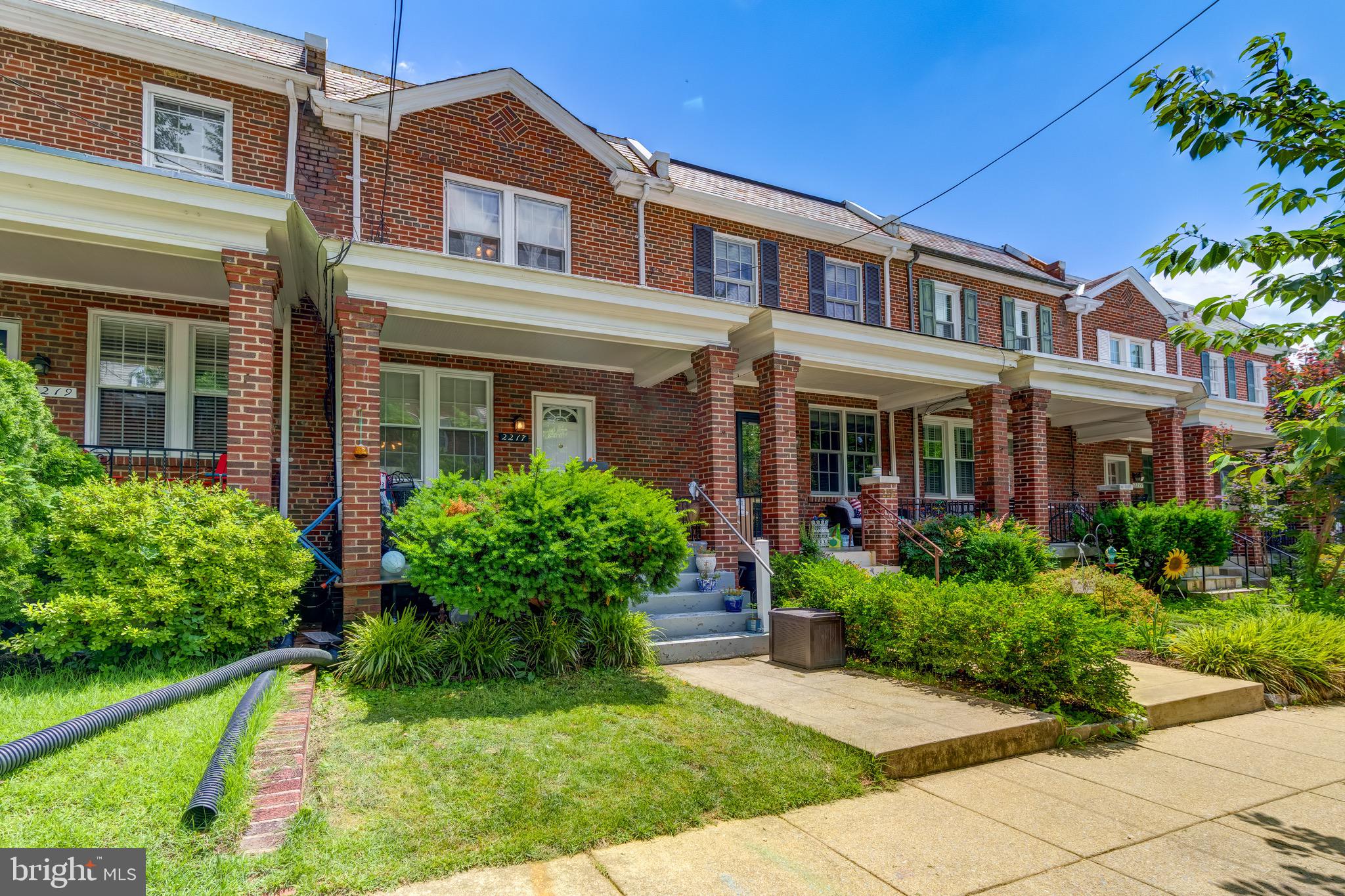 2217 39th Place Northwest Washington, DC 20007 - Photo 2 of 28 front view of a brick house with a yard