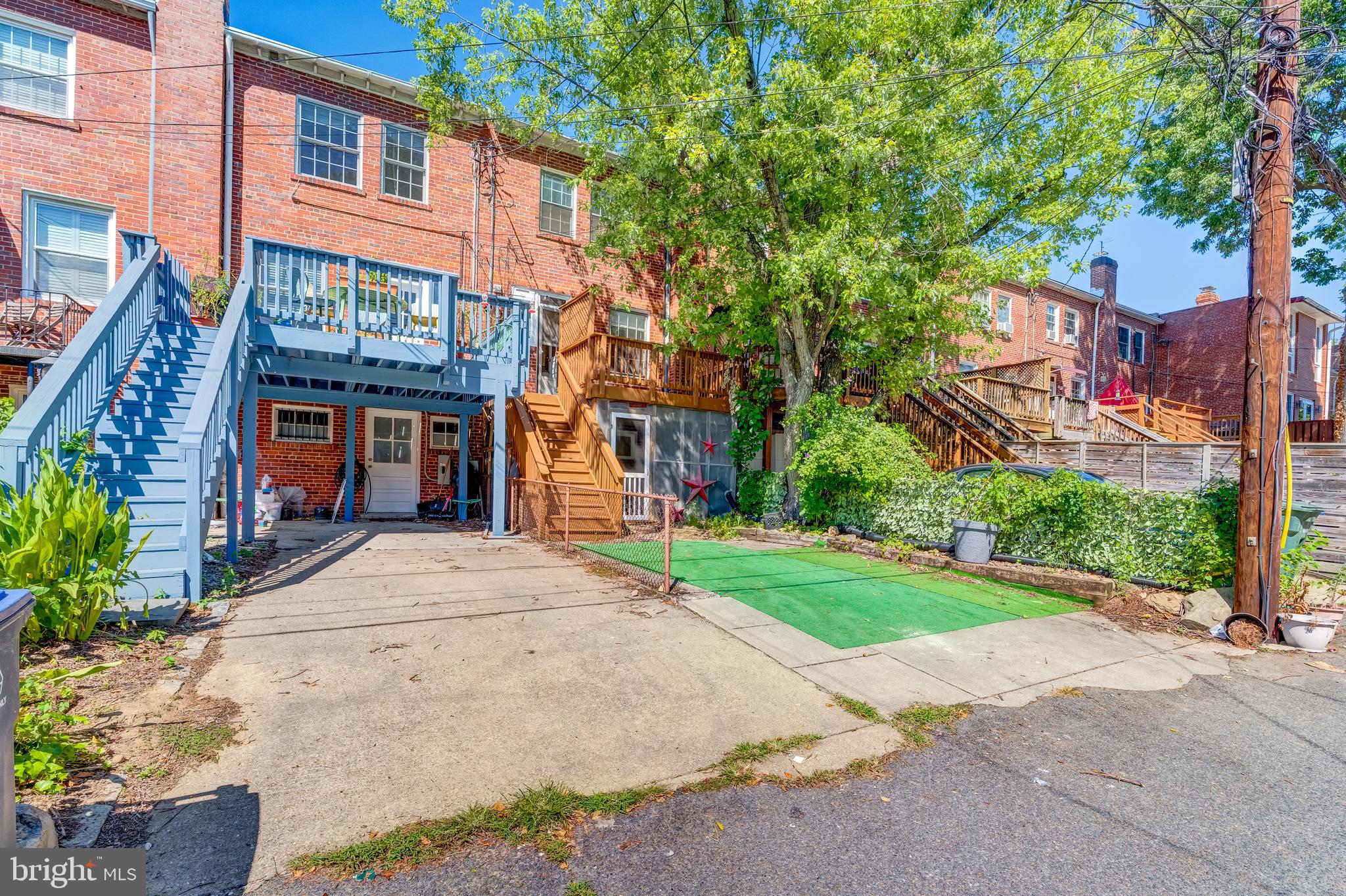 2217 39th Place Northwest Washington, DC 20007 - Photo 23 of 28 a front view of a house with a yard and potted plants
