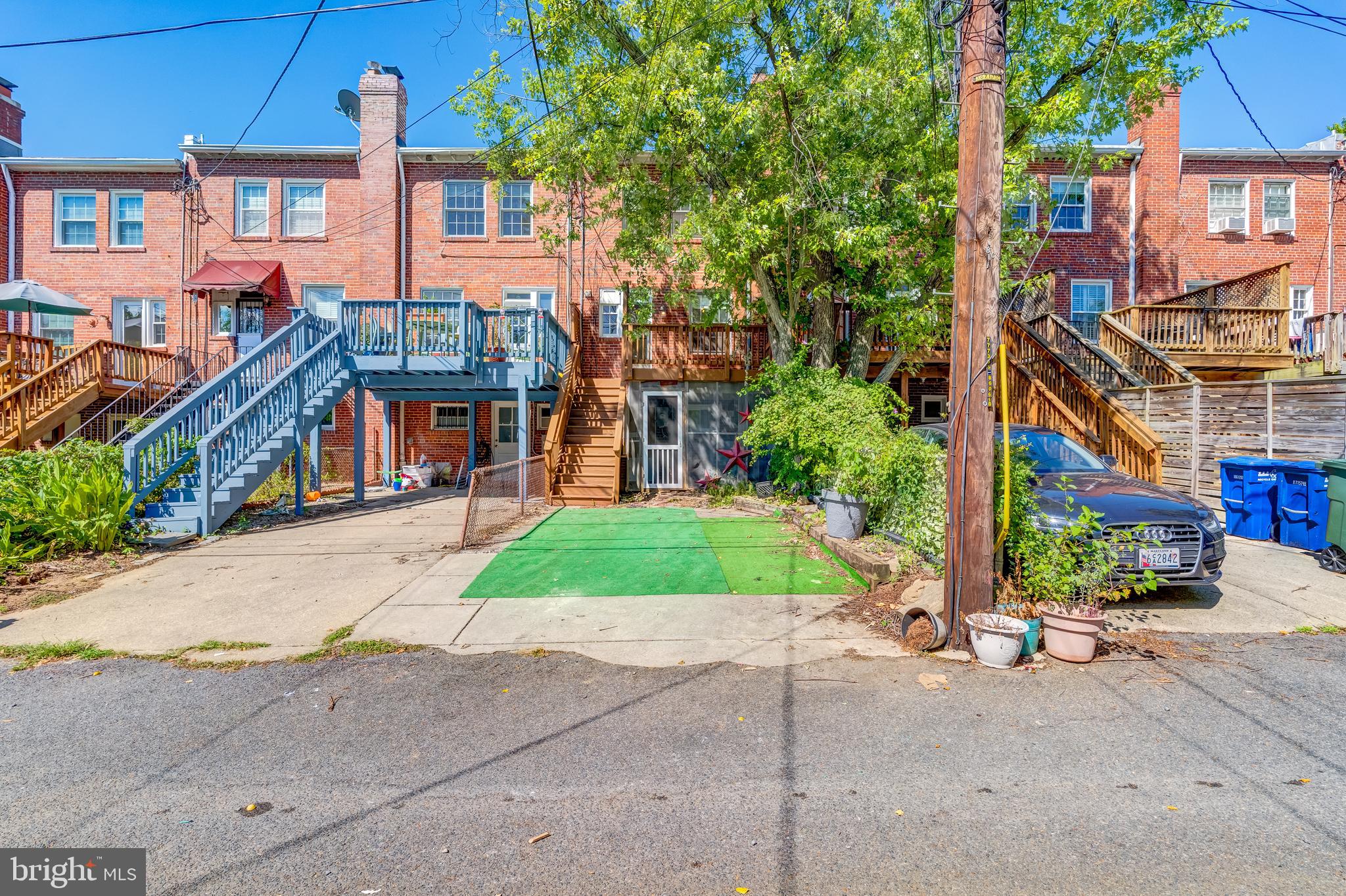 2217 39th Place Northwest Washington, DC 20007 - Photo 24 of 28 a front view of a house with a yard and potted plants