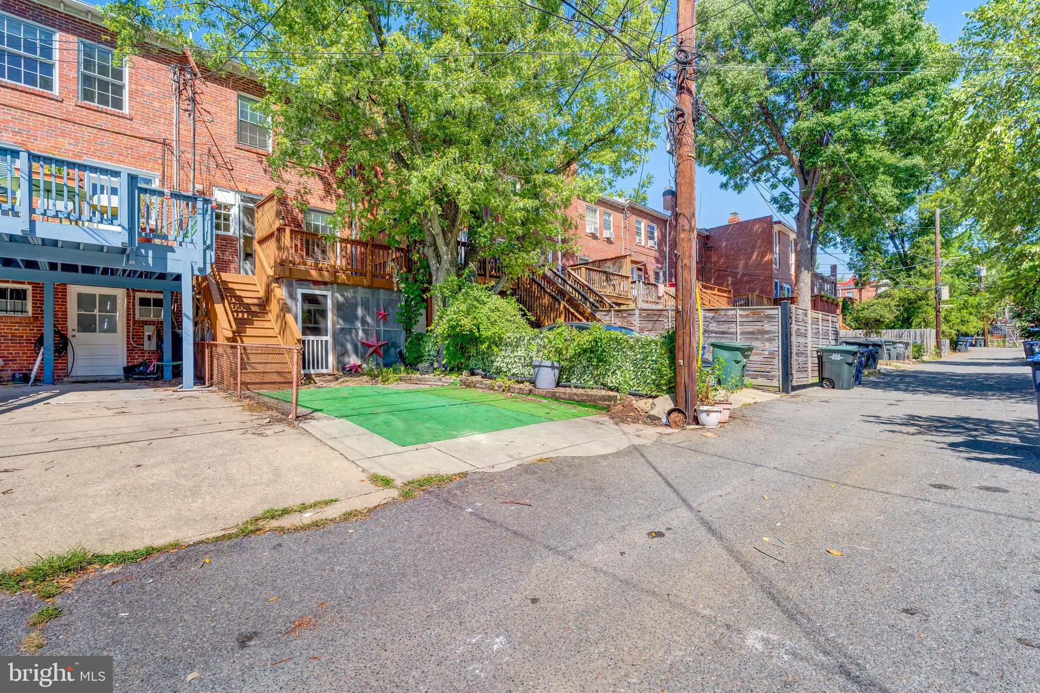 2217 39th Place Northwest Washington, DC 20007 - Photo 25 of 28 a view of a street with a building and trees in the background