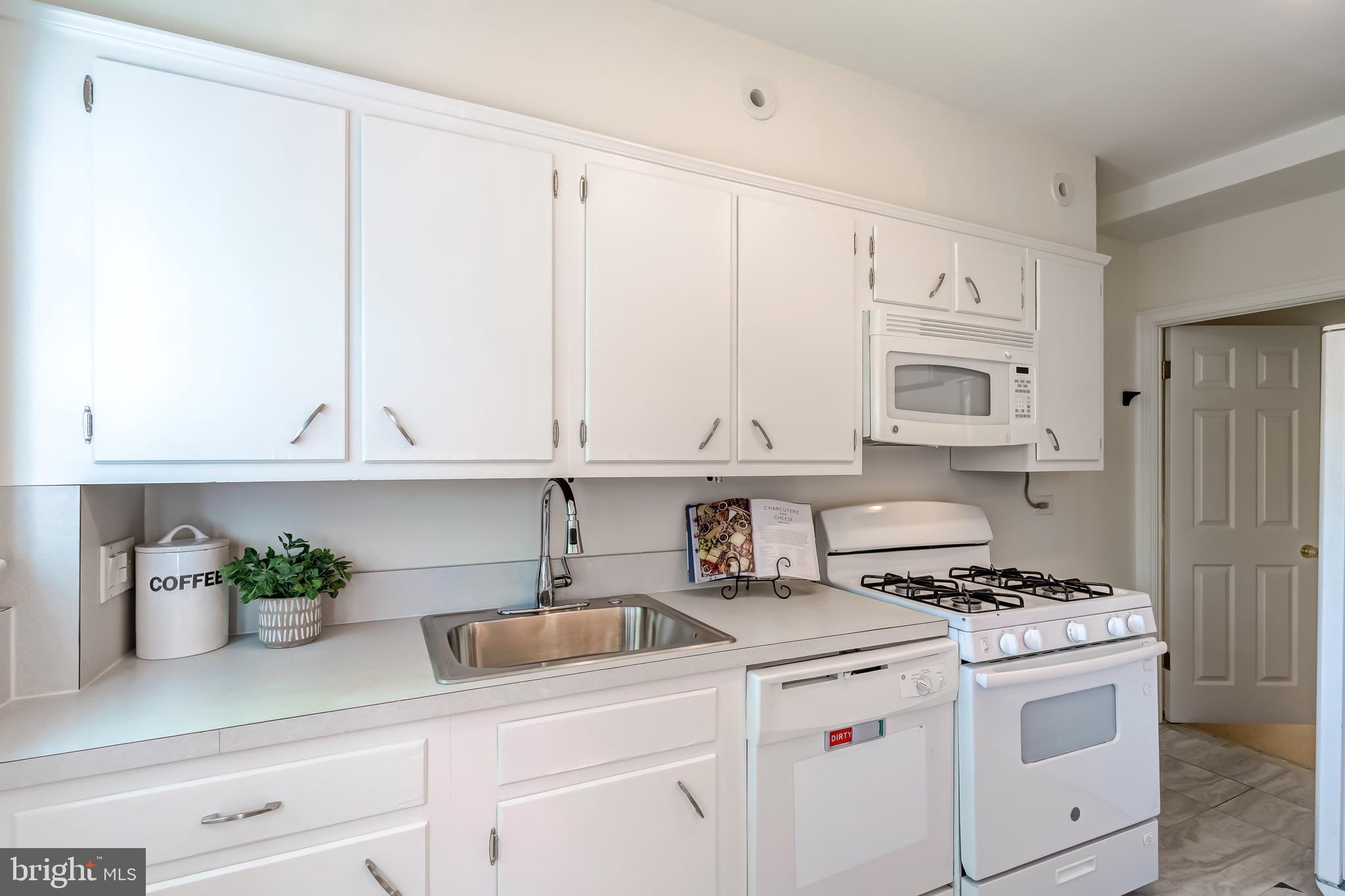 2217 39th Place Northwest Washington, DC 20007 - Photo 9 of 28 a kitchen with stainless steel appliances white cabinets and a stove