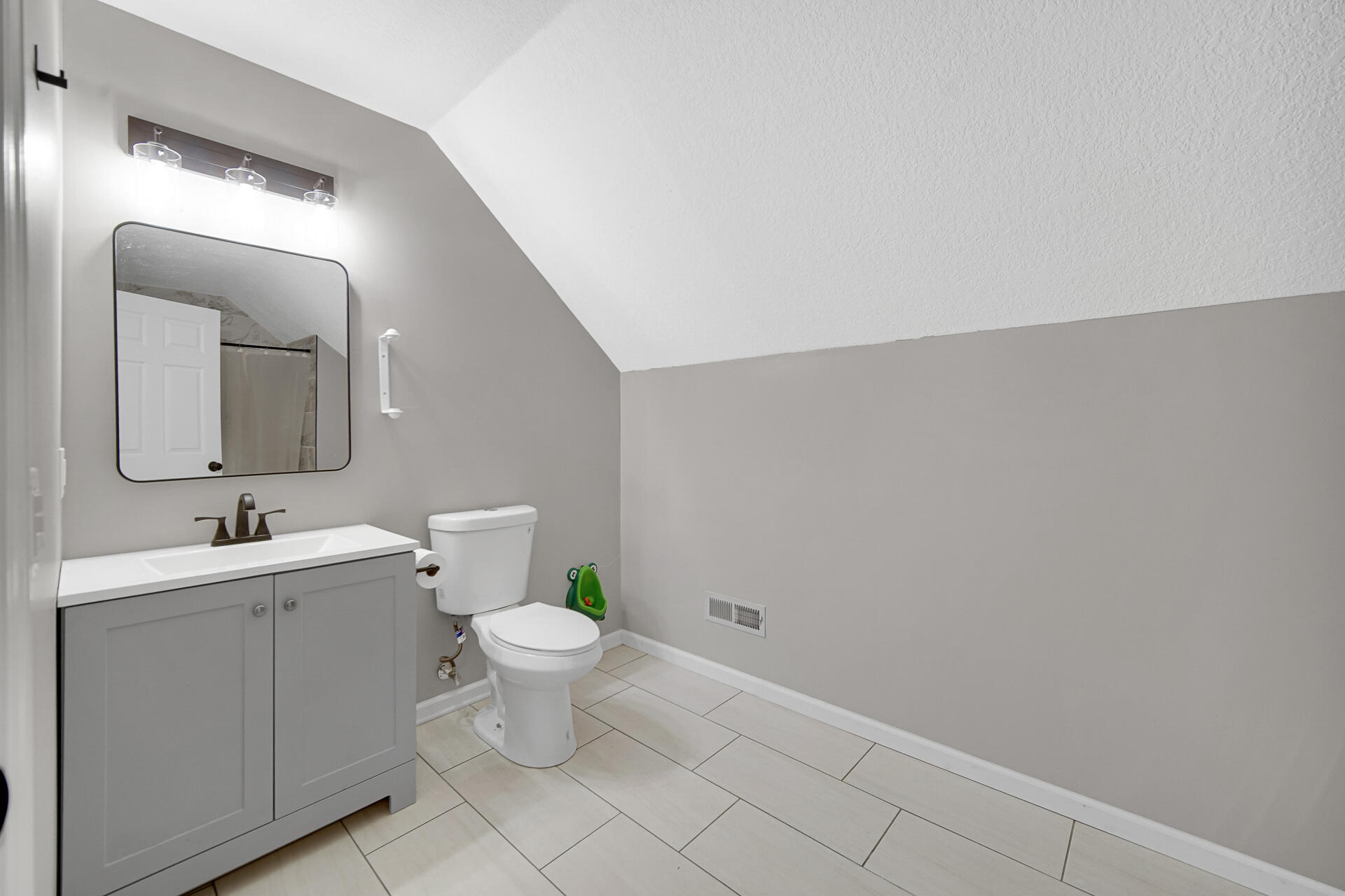 3028 West 15th Avenue Gary, IN 46404 - Photo 19 of 30 a bathroom with a toilet sink and mirror