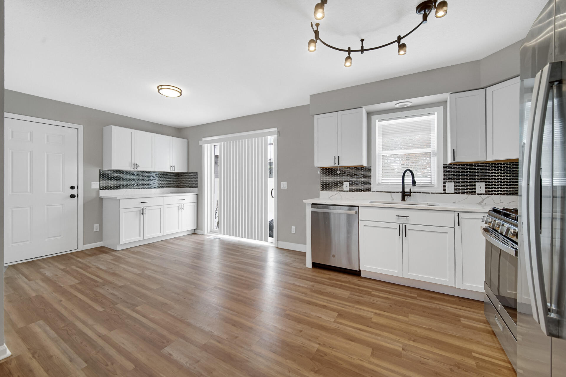 3028 West 15th Avenue Gary, IN 46404 - Photo 24 of 30 a kitchen with a sink cabinets stainless steel appliances and a window