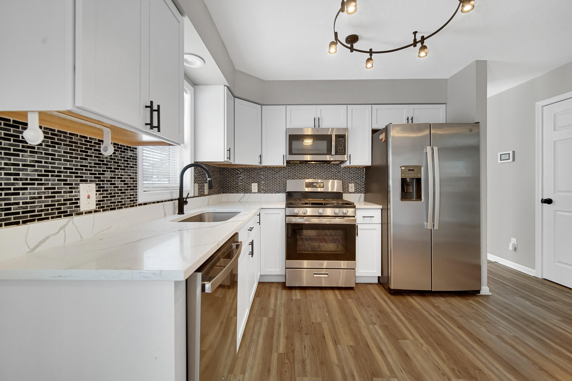 3028 West 15th Avenue Gary, IN 46404 - Photo 26 of 30 a kitchen with kitchen island granite countertop a sink appliances and cabinets