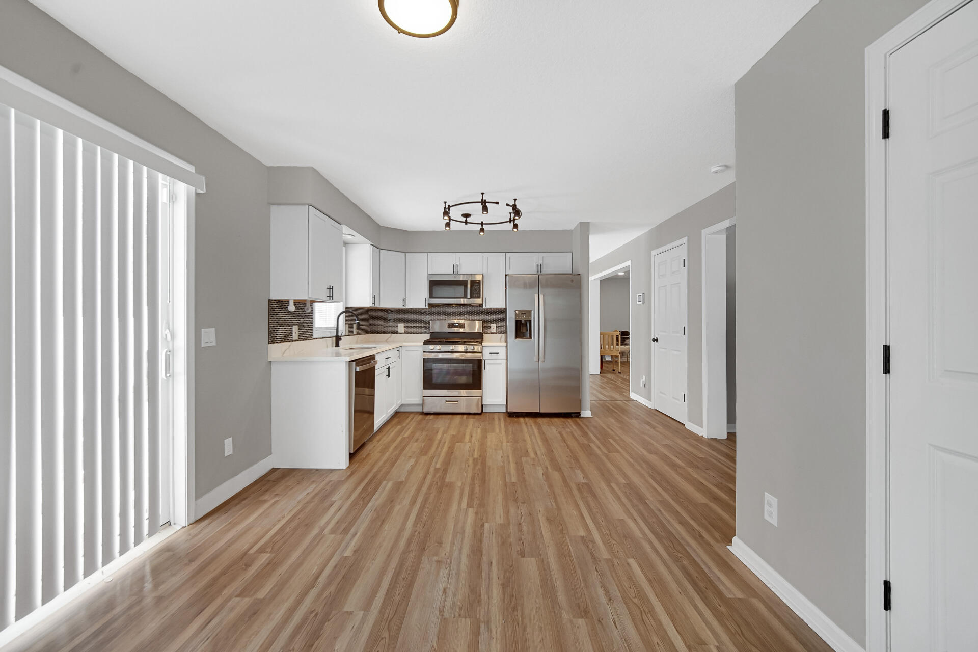 3028 West 15th Avenue Gary, IN 46404 - Photo 28 of 30 a kitchen with wooden floors and wooden cabinets