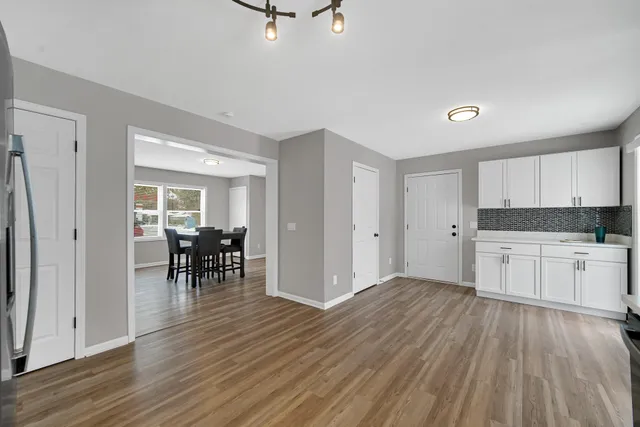 a view of a kitchen with dining space wooden floor and a sink