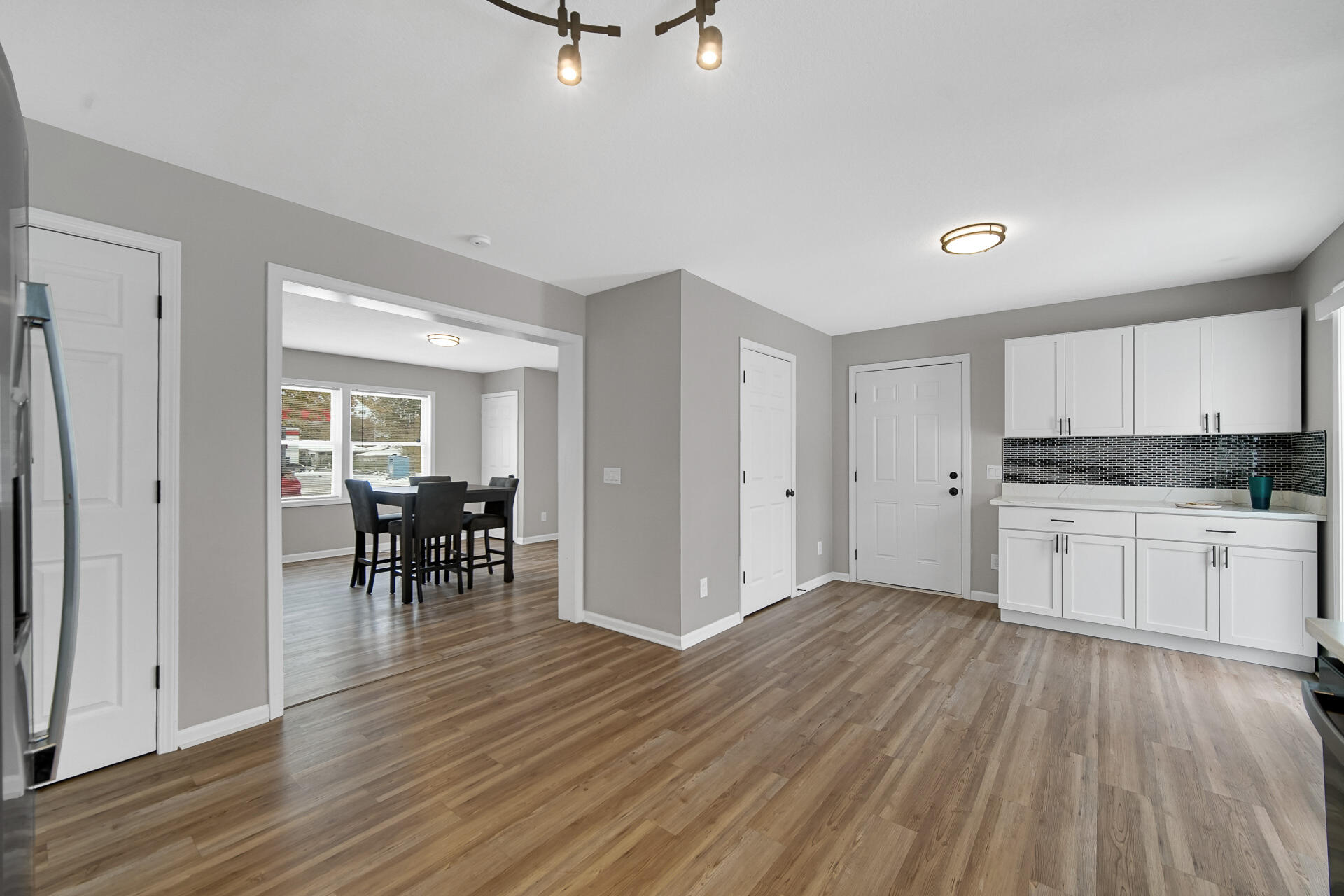 3028 West 15th Avenue Gary, IN 46404 - Photo 7 of 30 a view of a kitchen with dining space wooden floor and a sink