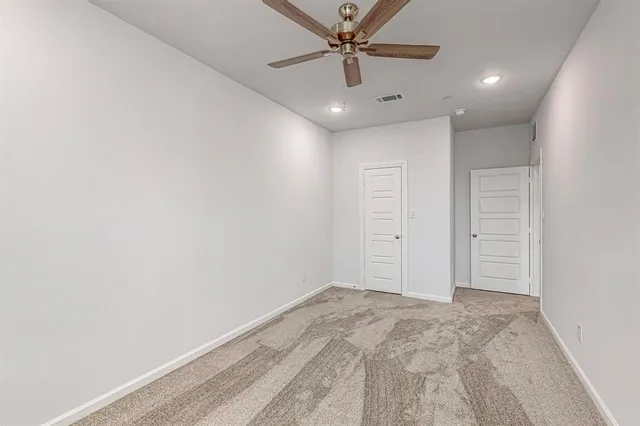 an empty room with a ceiling fan