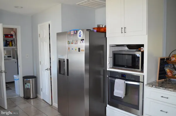 a kitchen with stainless steel appliances and refrigerator