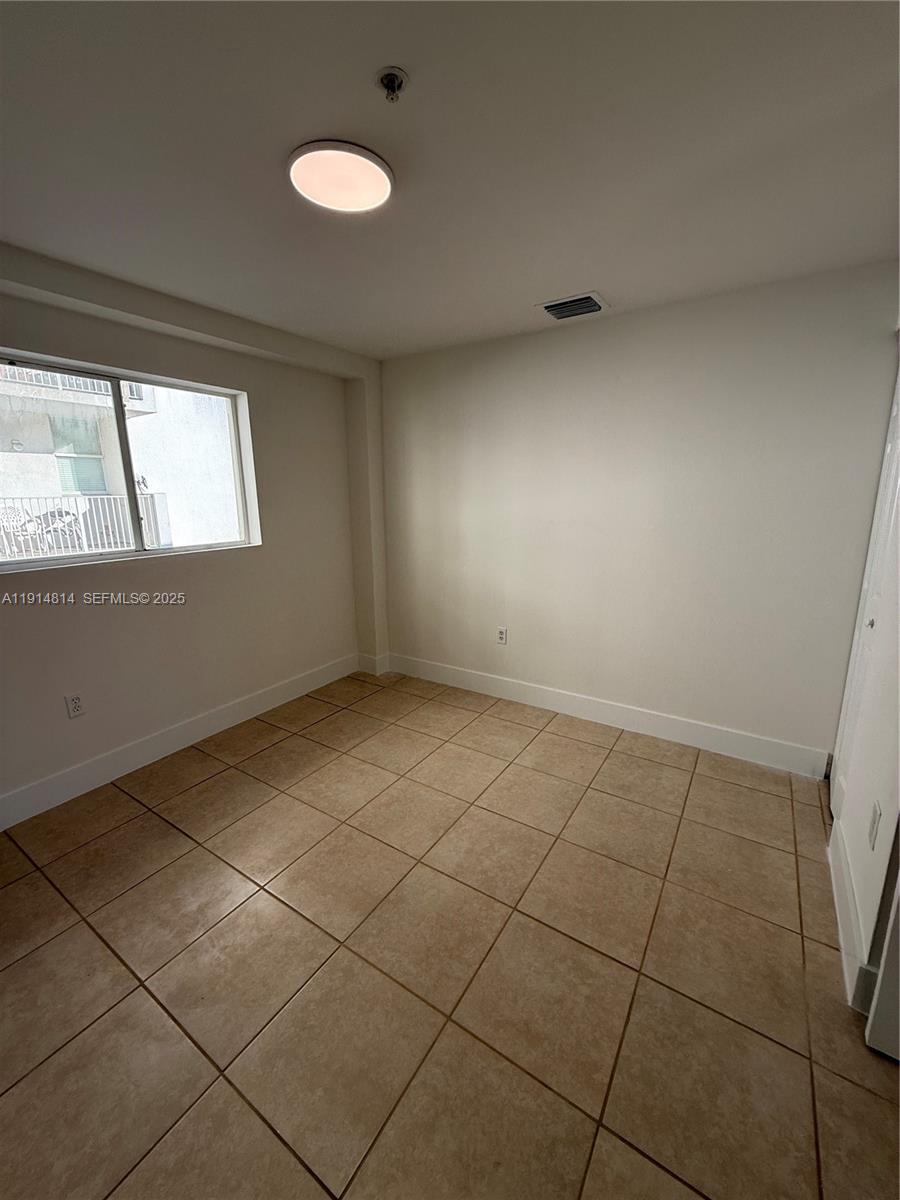 821 Southwest 2nd Street, Unit 7 Miami, FL 33130 - Photo 11 of 29 a view of an empty room with a window