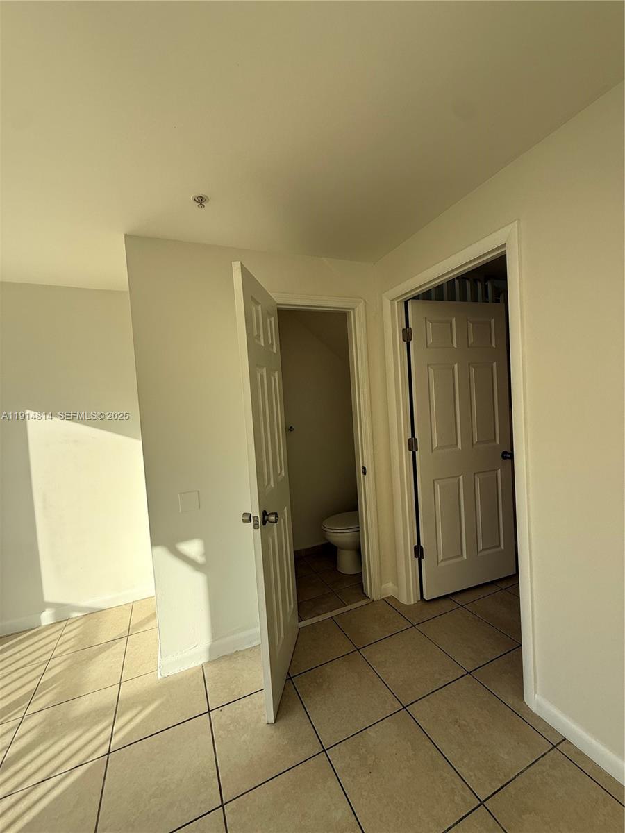 821 Southwest 2nd Street, Unit 7 Miami, FL 33130 - Photo 13 of 29 a bathroom with a granite countertop sink and a mirror