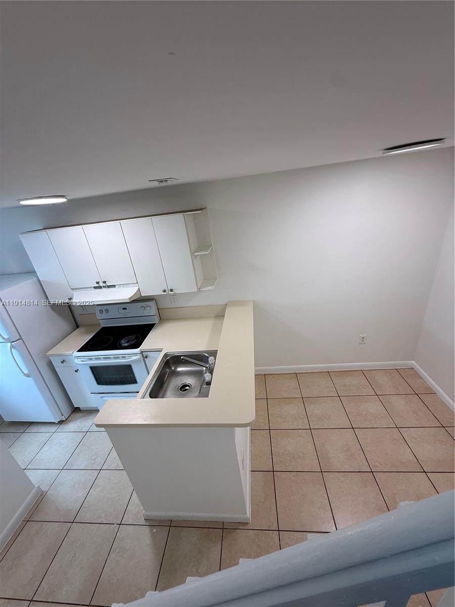 821 Southwest 2nd Street, Unit 7 Miami, FL 33130 - Photo 22 of 29 a kitchen with a sink and a stove top oven