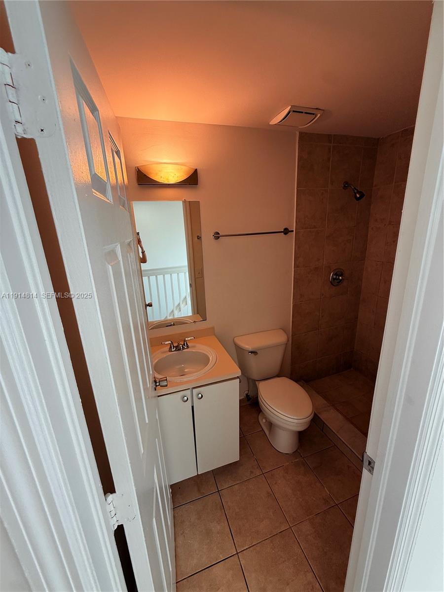 821 Southwest 2nd Street, Unit 7 Miami, FL 33130 - Photo 26 of 29 a bathroom with a granite countertop toilet and a sink