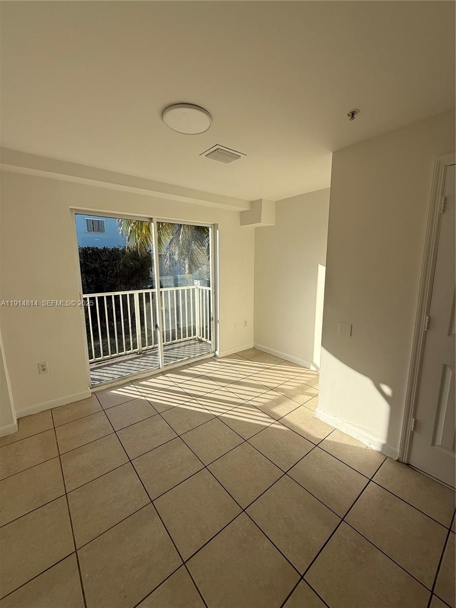 821 Southwest 2nd Street, Unit 7 Miami, FL 33130 - Photo 3 of 29 a view of an empty room and glass door
