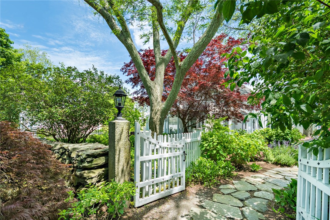 1510 Boston Neck Road North Kingstown, RI 02874 - Photo 5 of 40 Stone walls, granite hitching posts, garden gates, arbor of shade trees and a walking stone path leads to the front door