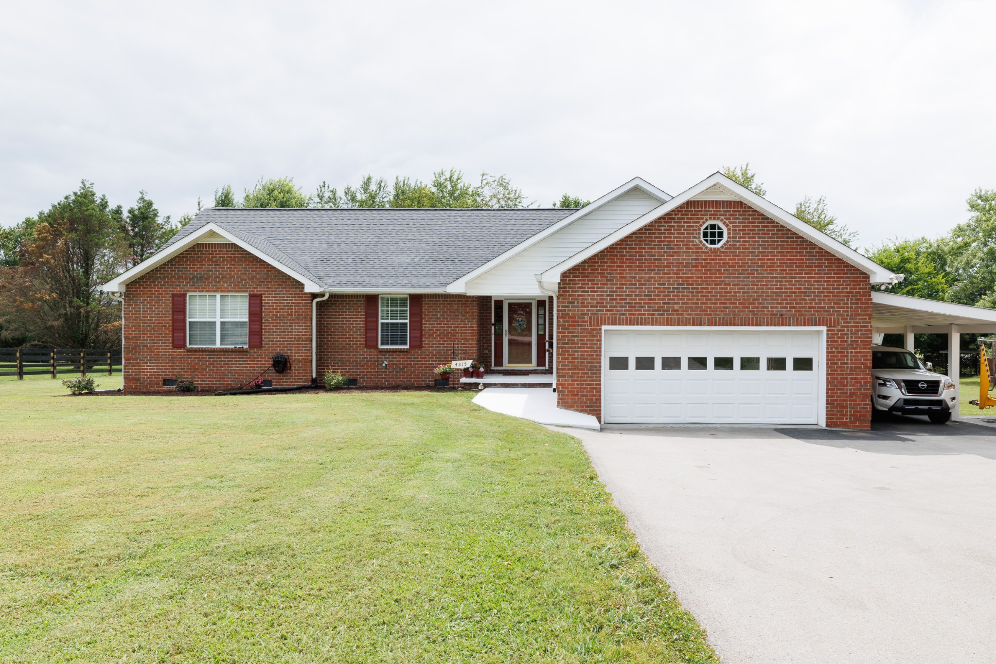 a view of a house with a yard and garage