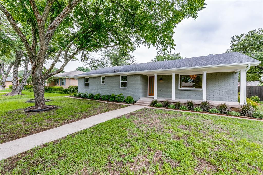 a view of an house with backyard space and garden