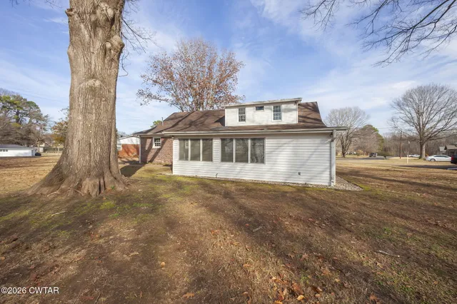 a big yard with trees in the background