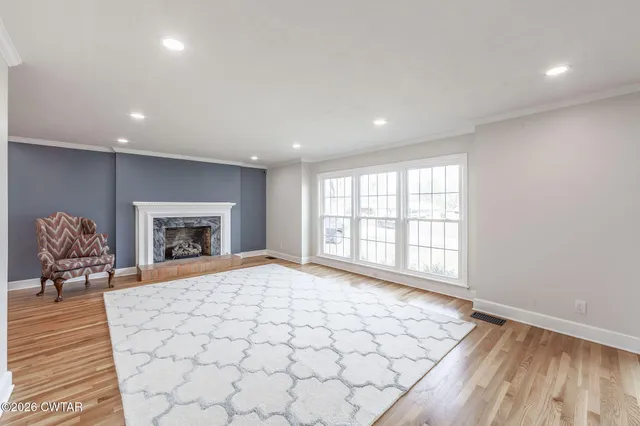 a large bedroom with a bed and a fireplace