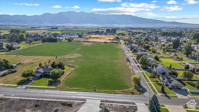 294 West 3400 South, Unit 9 Logan, UT 84321 - Photo 9 of 24 Aerial perspective of suburban area featuring a mountain backdrop