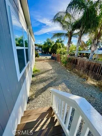 a view of a porch with furniture and a yard