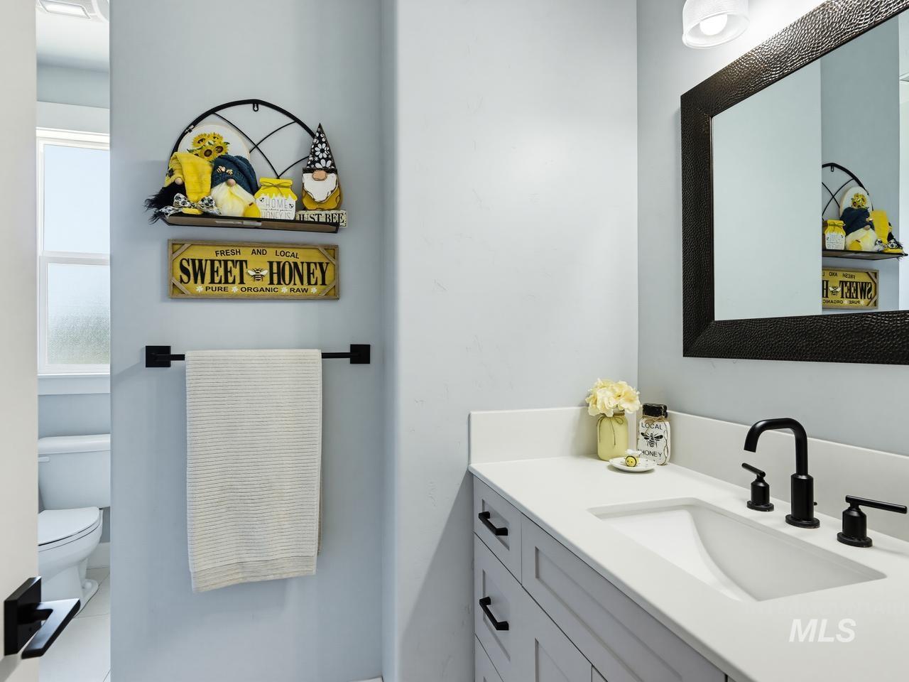 4950 West Columbia Road Nampa, ID 83687 - Photo 28 of 50 Vanity featuring a light gray cabinet with matte black hardware, white countertop, and integrated white sink