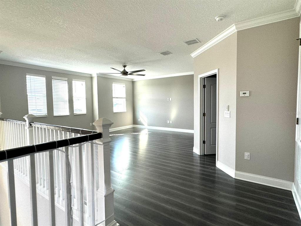 12411 Northover Loop Orlando, FL 32824 - Photo 11 of 13 a view of a hallway with wooden floor and stairs