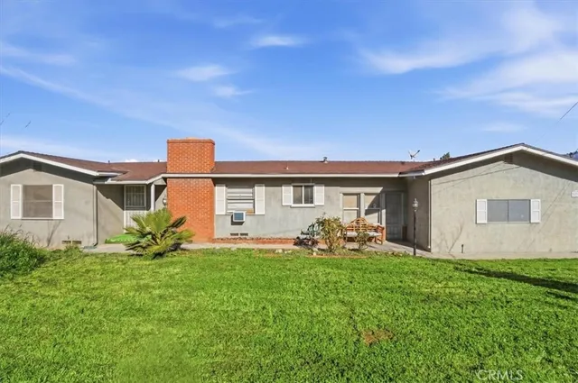 a front view of house with yard and outdoor seating