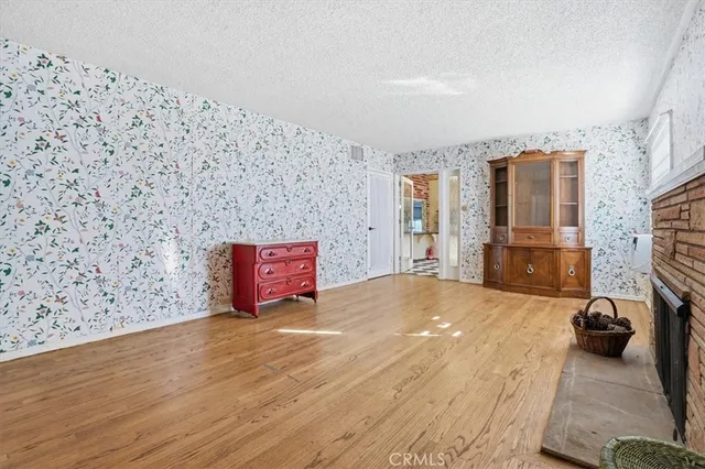 a spacious bedroom with a bed and a flat screen tv