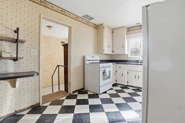 a kitchen with stainless steel appliances a refrigerator and cabinets