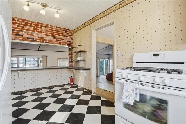 a kitchen with a stove top oven and cabinets
