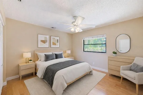 a bedroom with a bed and a chandelier