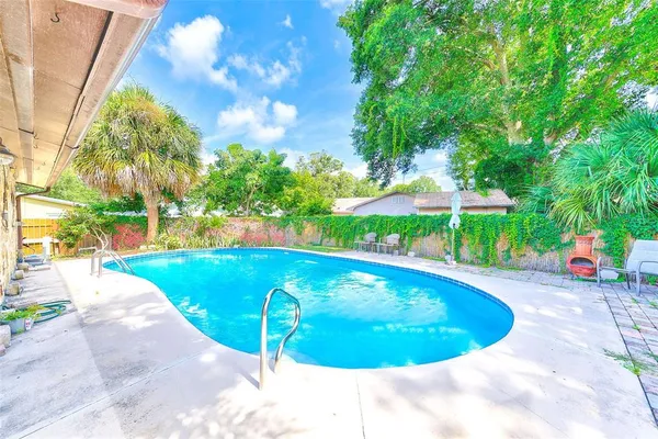 a view of a swimming pool in the backyard of house