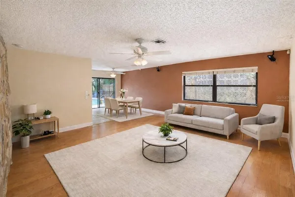 a living room with furniture and a potted plant