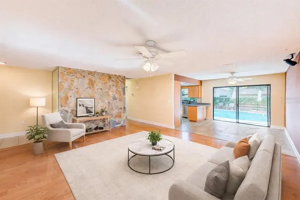 a living room with furniture potted plant and a large window